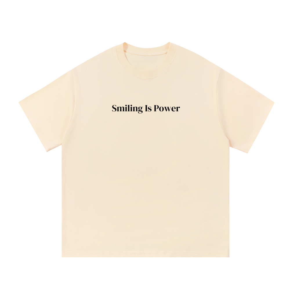 The Name Tee in bone, front: Smiling Is Power set across the chest in ink