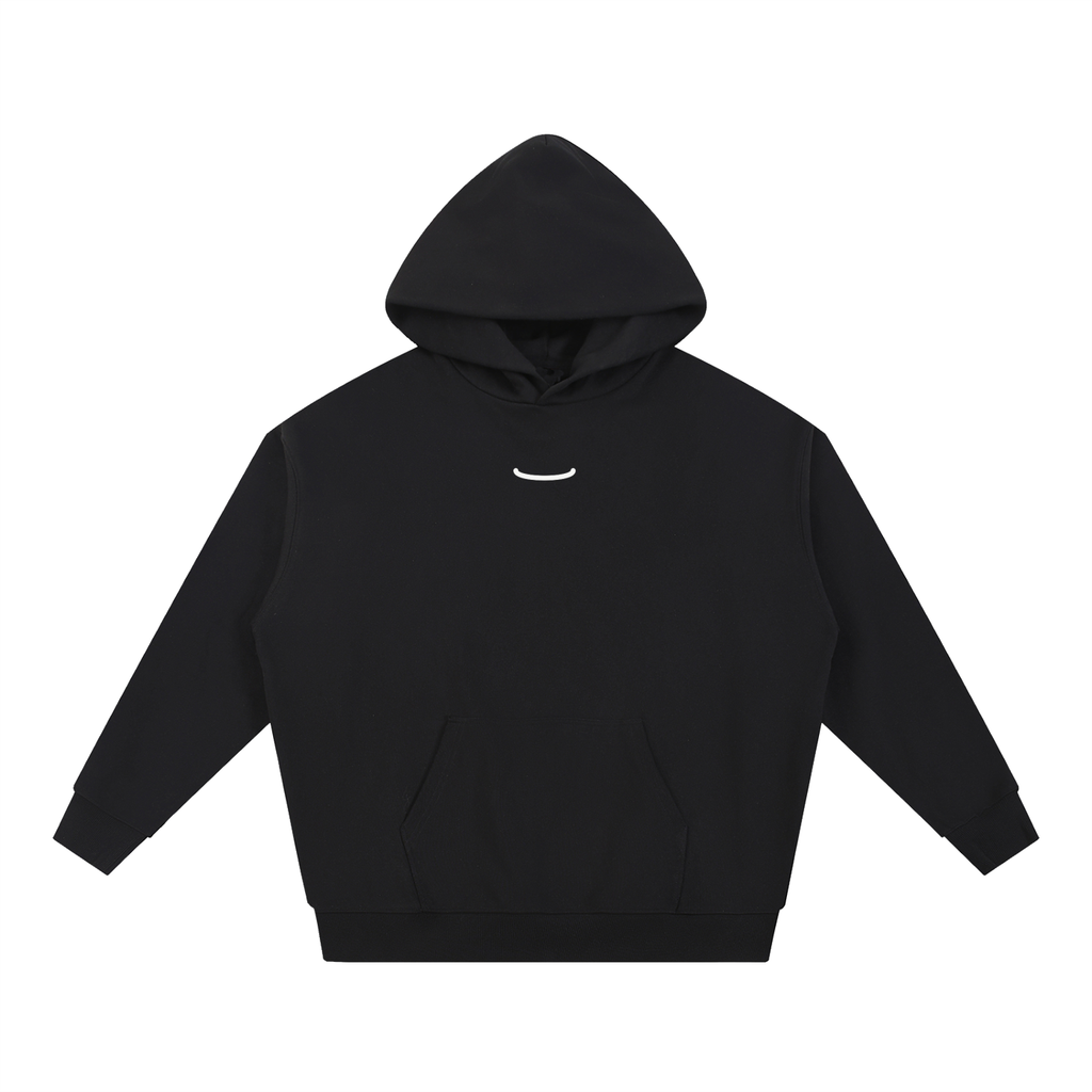 The Arc Hoodie in Ink, front: black heavyweight hoodie with one small bone smile arc centred on the chest